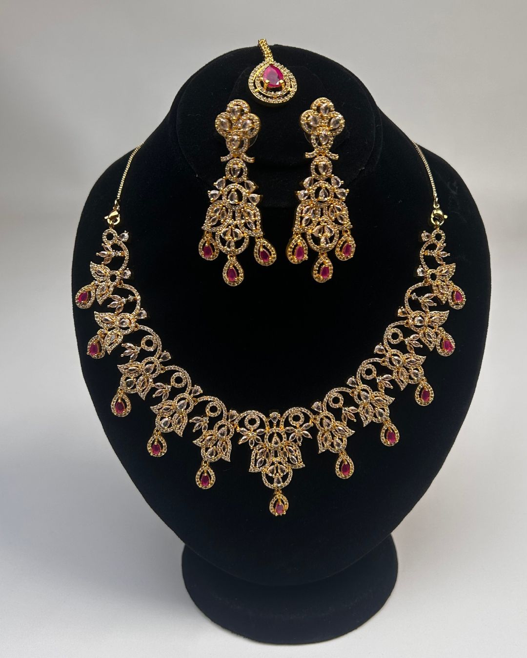 Gold Zircon Party Wear Jewelry Set with Earrings & Tikka