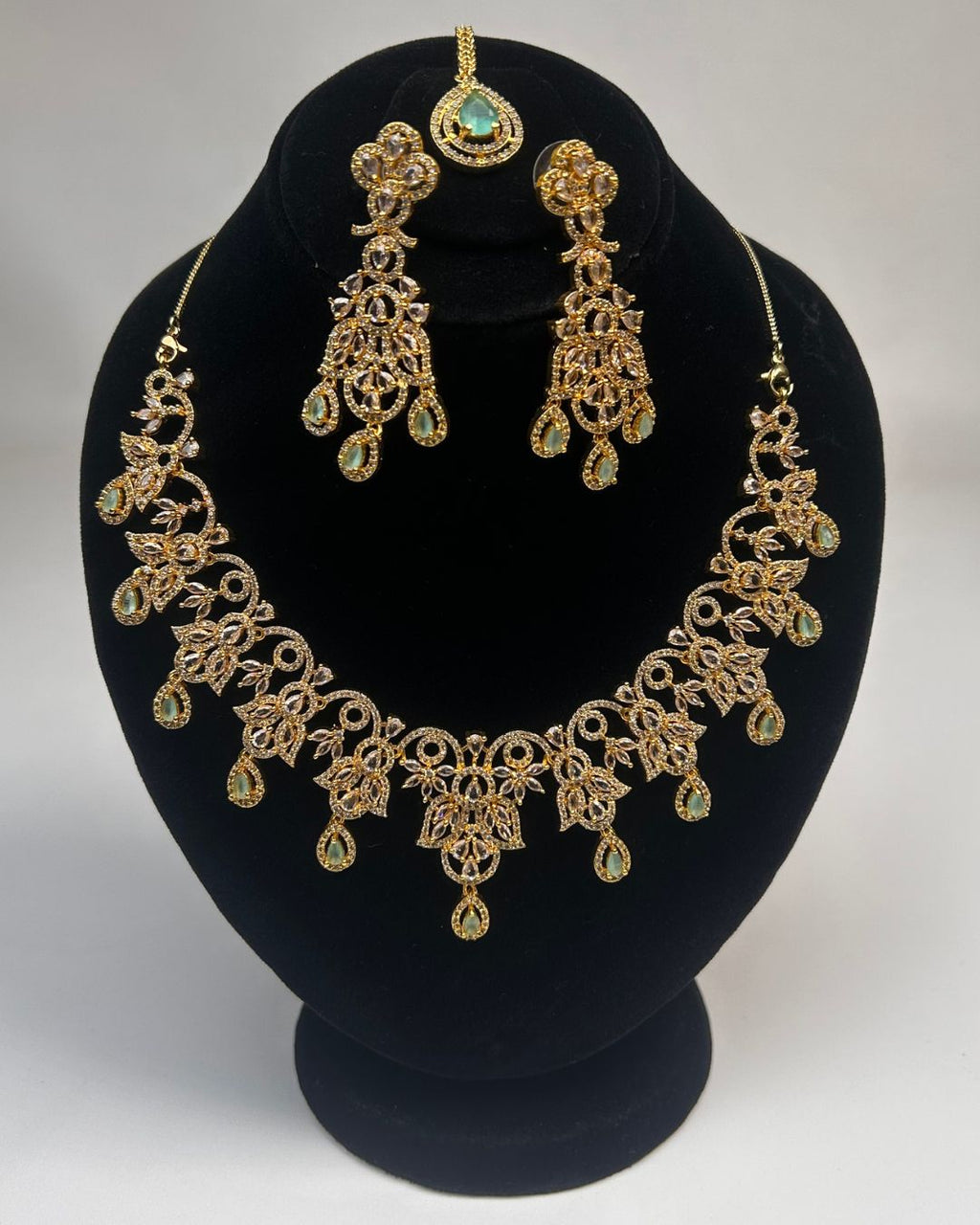 Gold Zircon Party Wear Jewelry Set with Earrings & Tikka