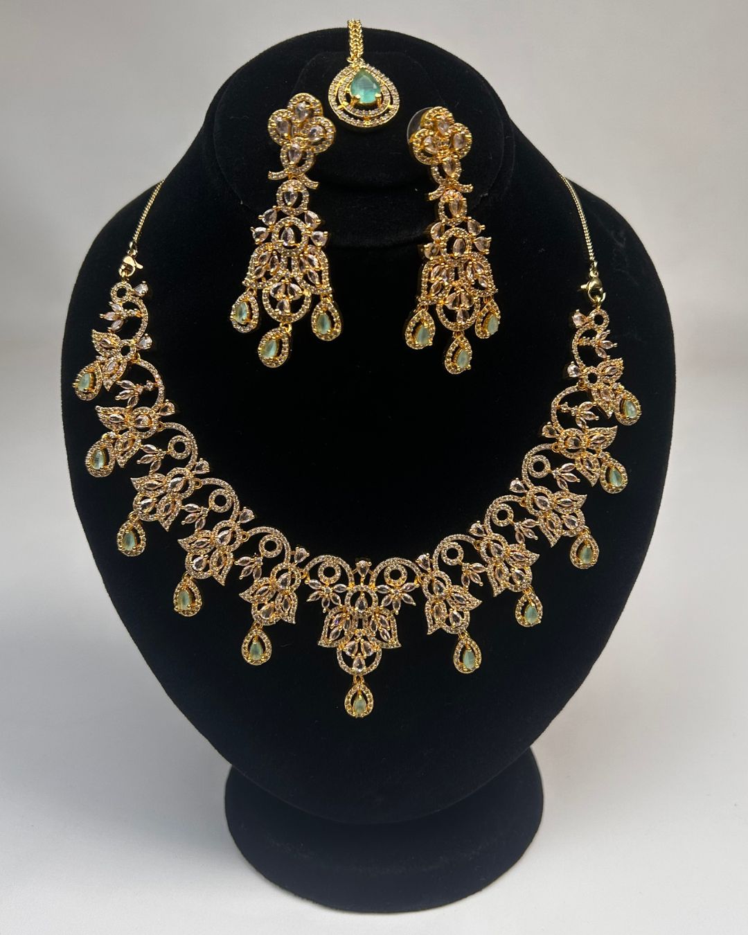 Gold Zircon Party Wear Jewelry Set with Earrings & Tikka