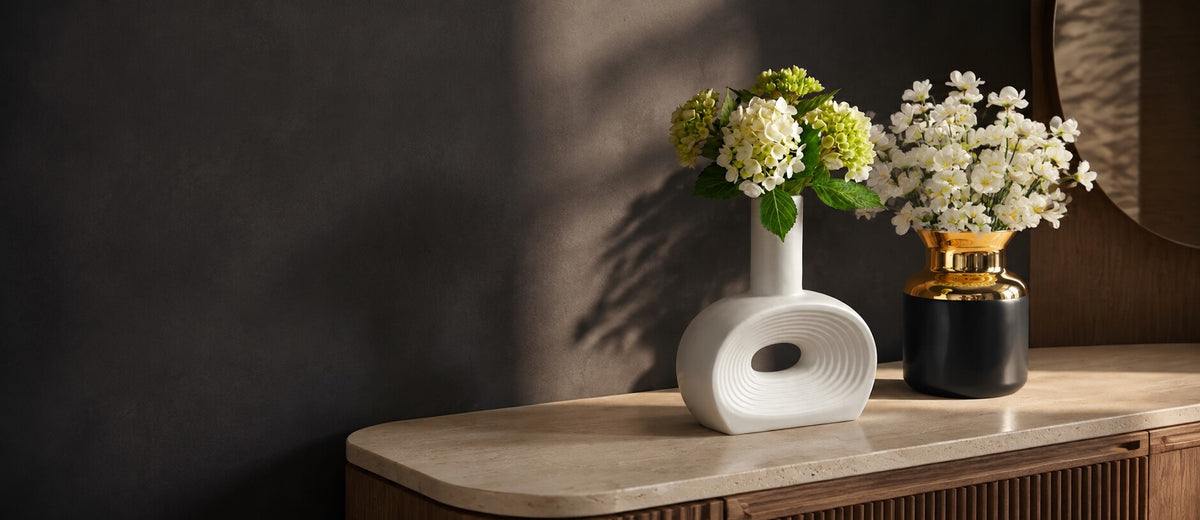 White sculptural vase and black gold-rim vase from Zurein